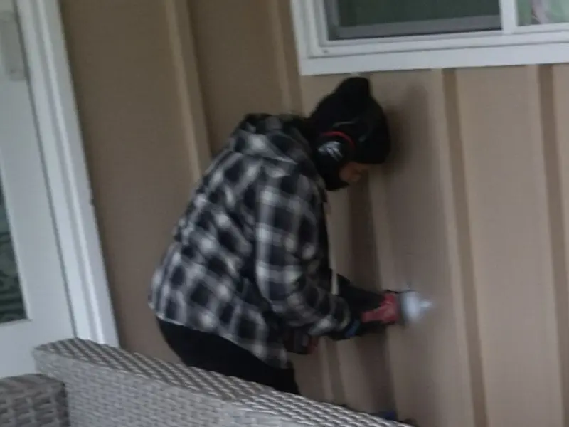 Professional electrician installing an exterior outlet in Massac