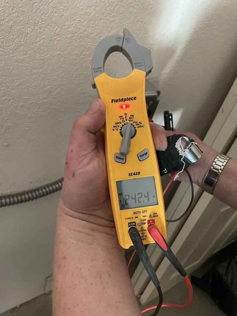 Voltage testing with clamp meter during Ceiling Fan Installation in Massac